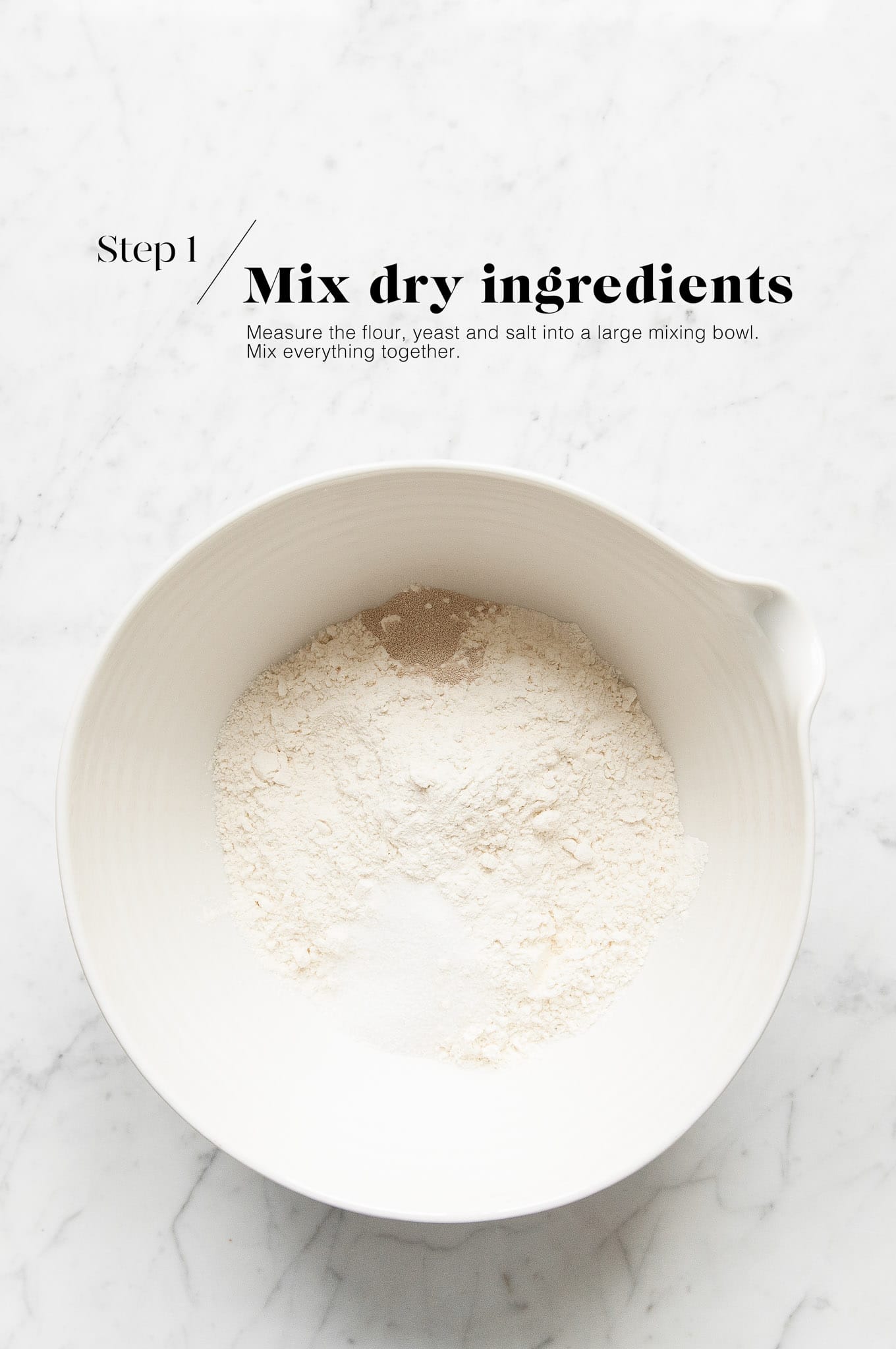 dry ingredients for no knead bread in white mixing bowl