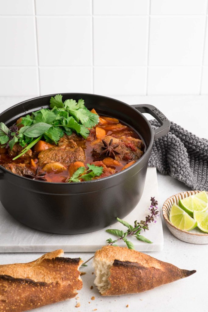 vietnamese beef stew bo kho with fresh herbs and baguette