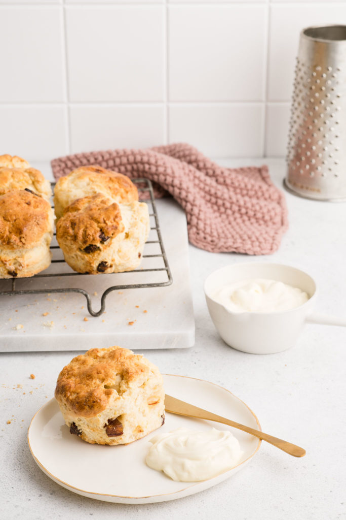 date scones on plate with whipped cream