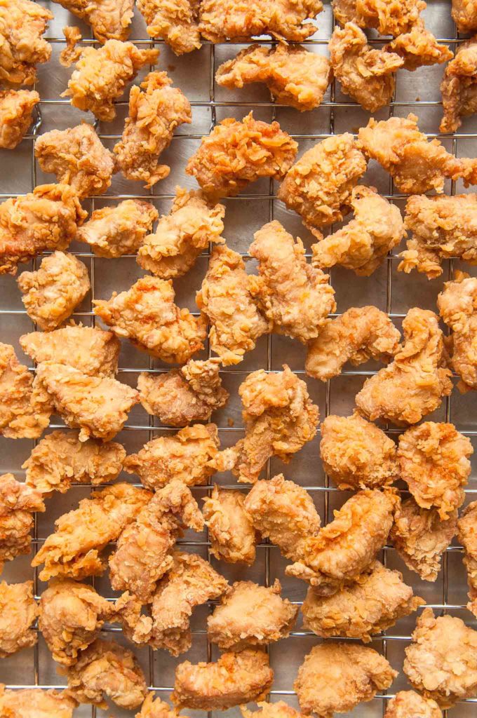 fried chicken pieces on wire rack