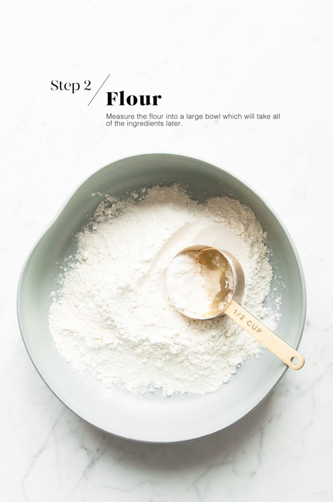 flour in large bowl with measuring spoon