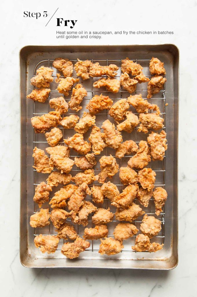 fried chicken pieces on baking tray