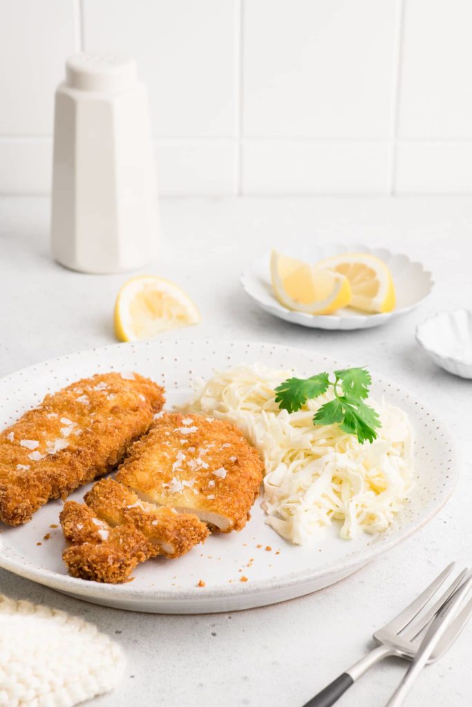 chicken schnitzel on plate with cabbage