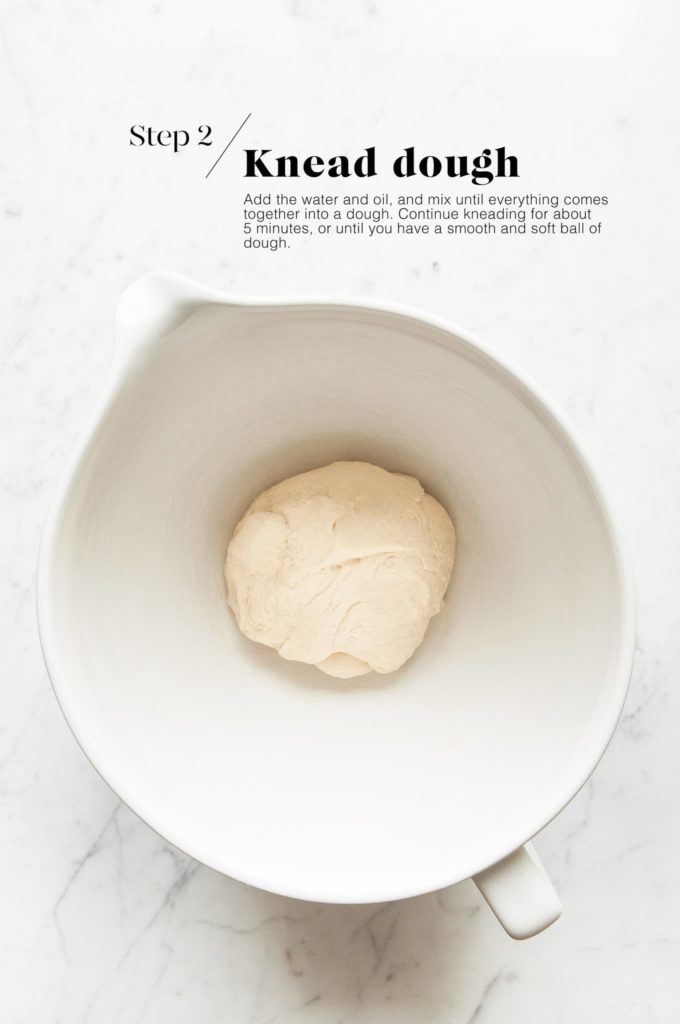 focaccia dough in white mixing bowl