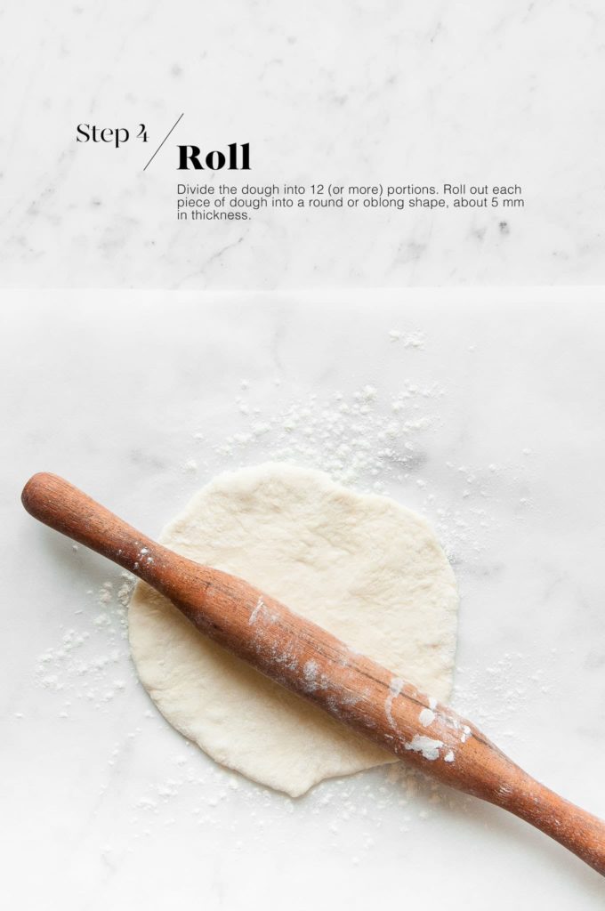rolled out flatbread dough with wooden rolling pin