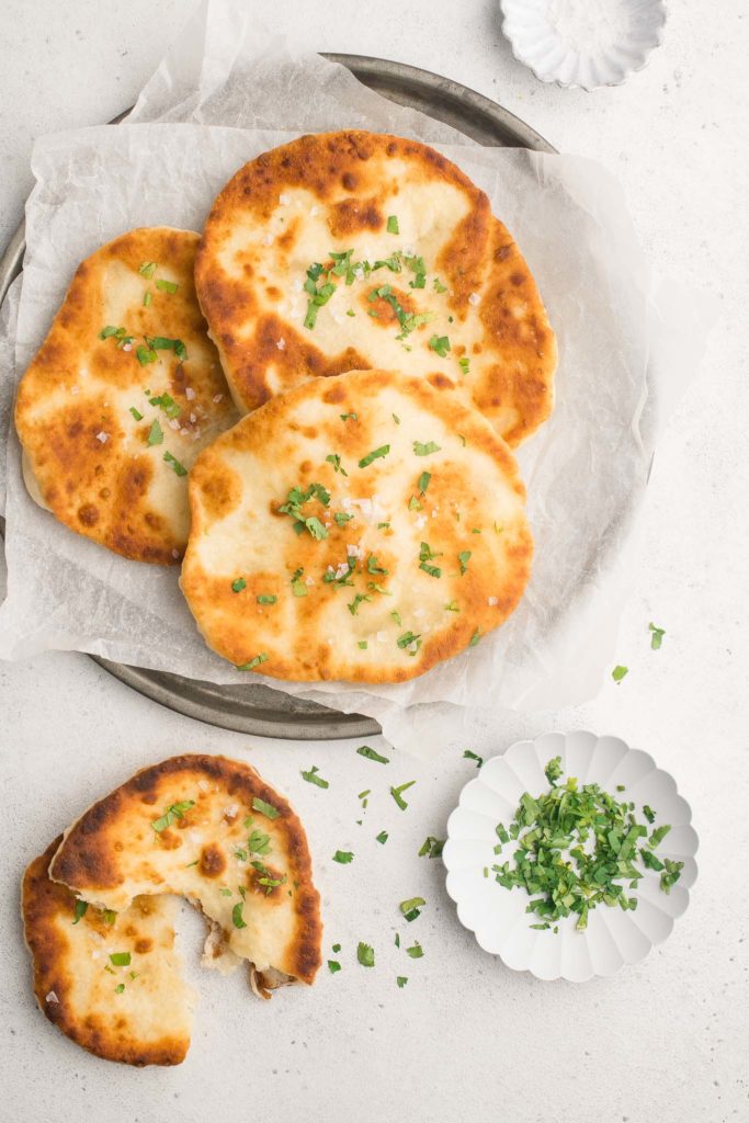 yoghurt flatbreads on plate with herbs