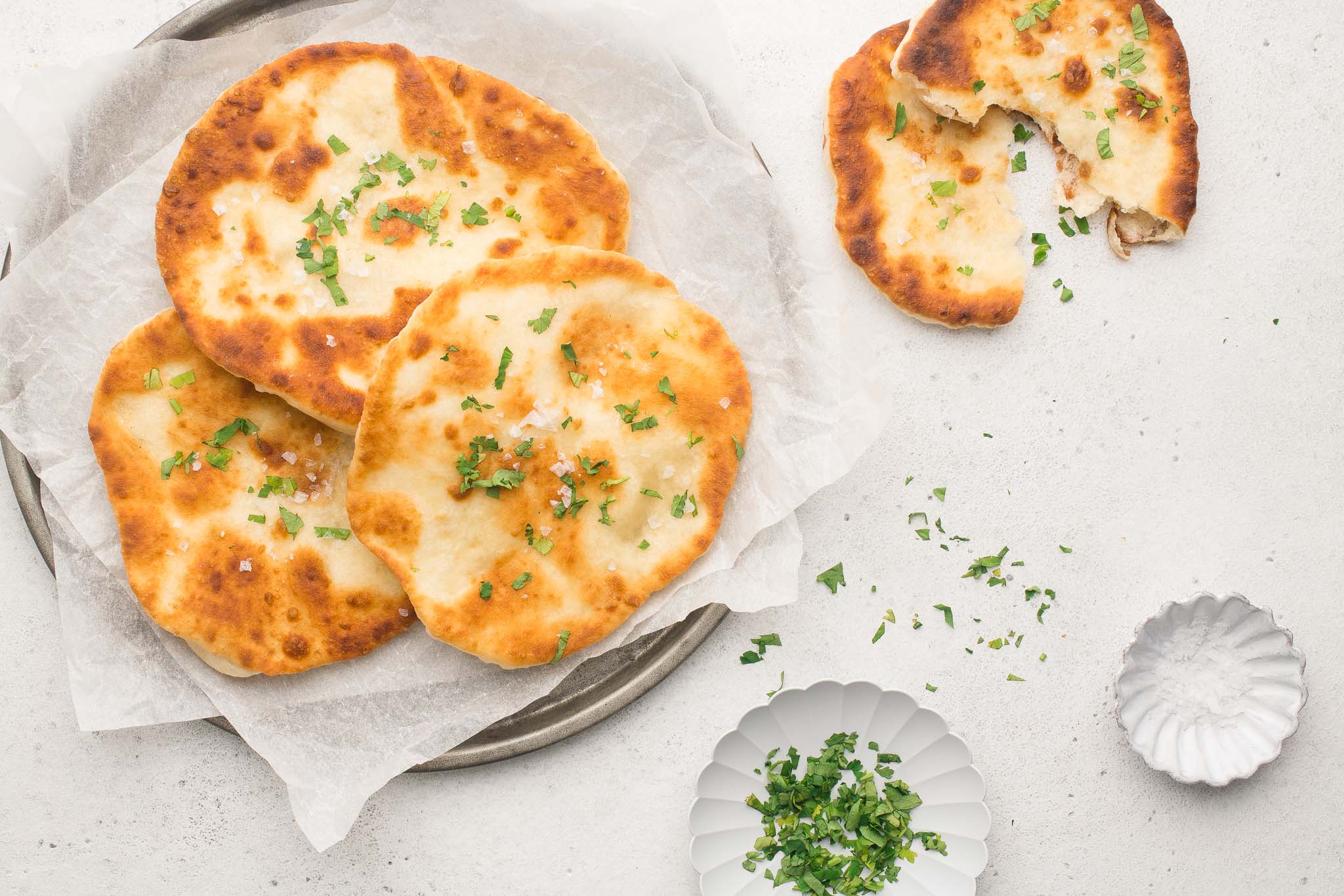 flatbreads on plate with sprinkled herbs
