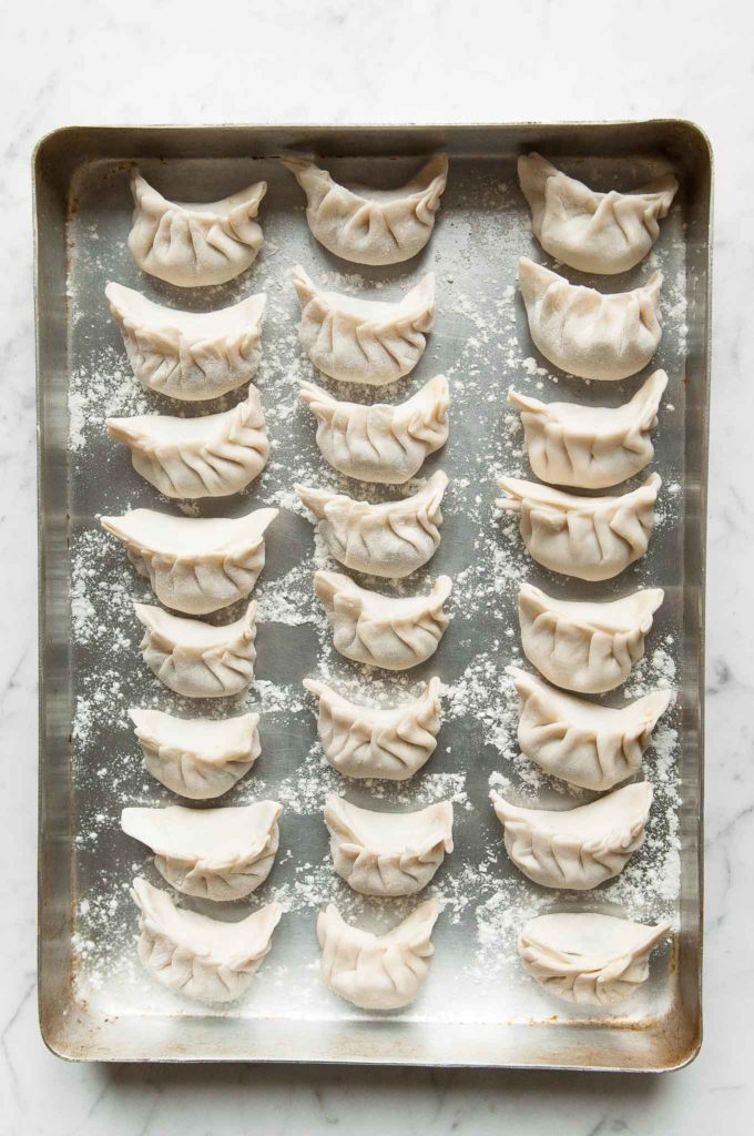 homemade dumplings on baking sheet