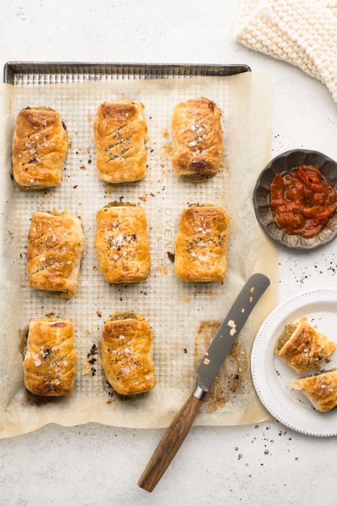 pork sausage rolls on baking tray with knife