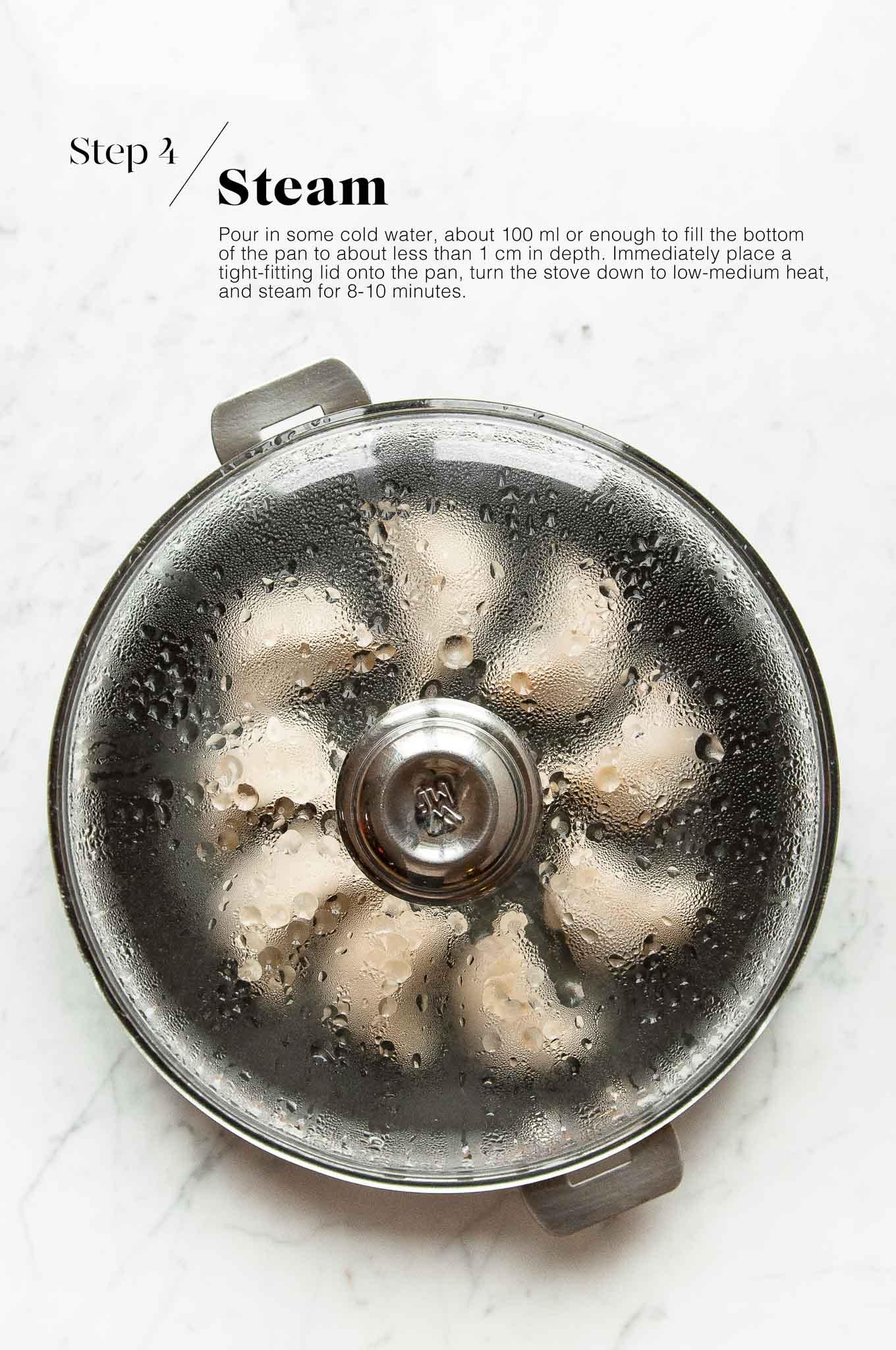 steaming potstickers in large pan