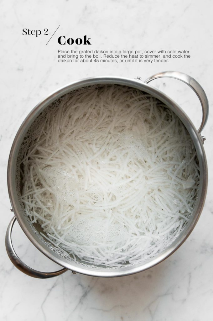 grated daikon radish in pot with water