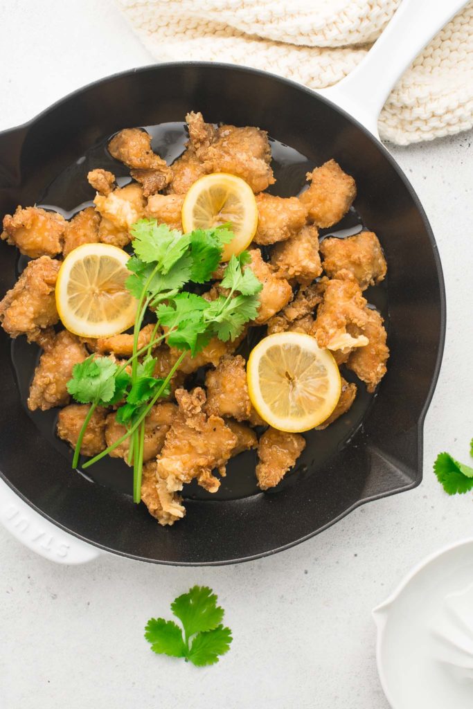 chinese lemon chicken in pan with cilantro