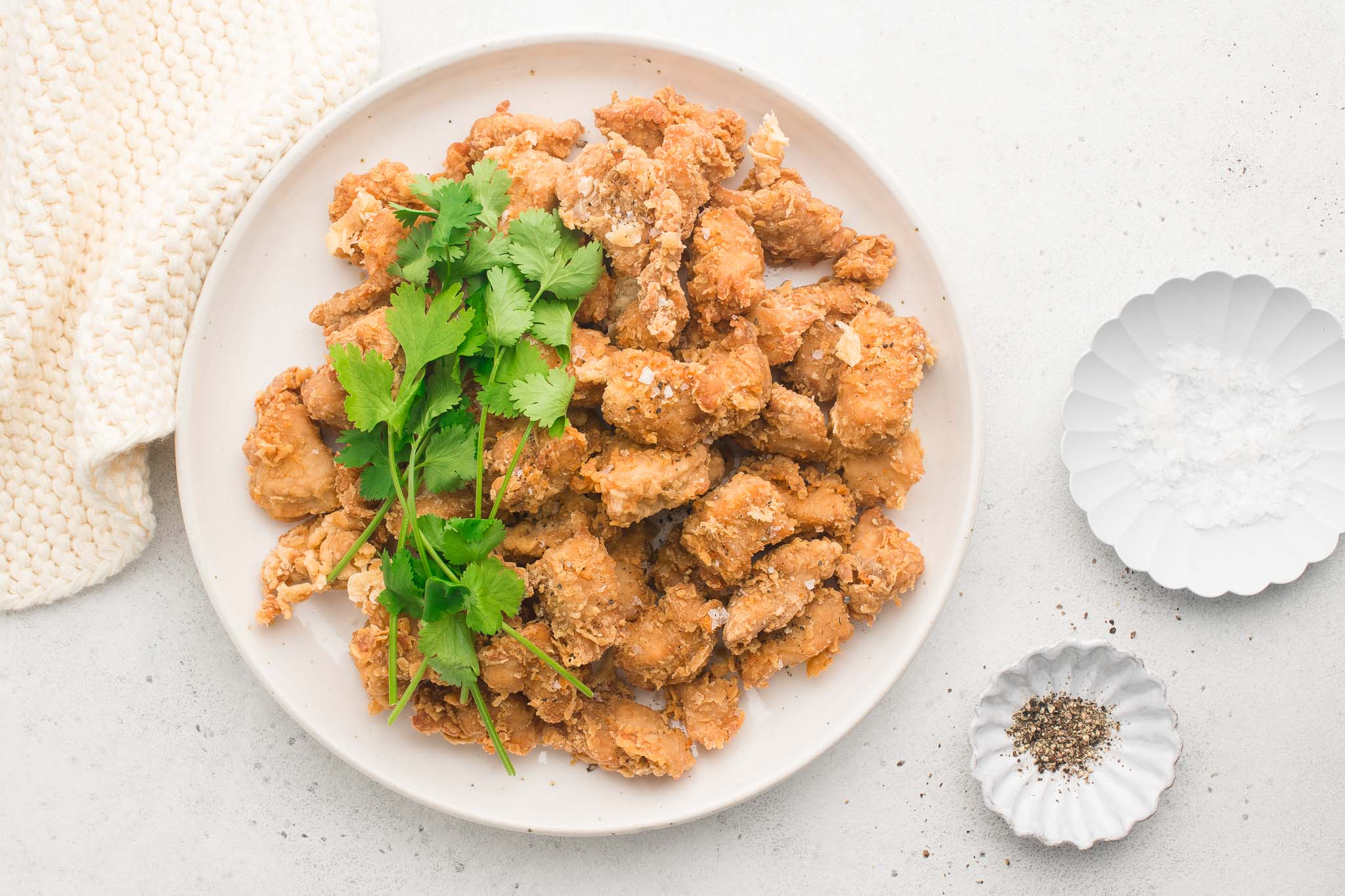 popcorn chicken on large plate with fresh herbs