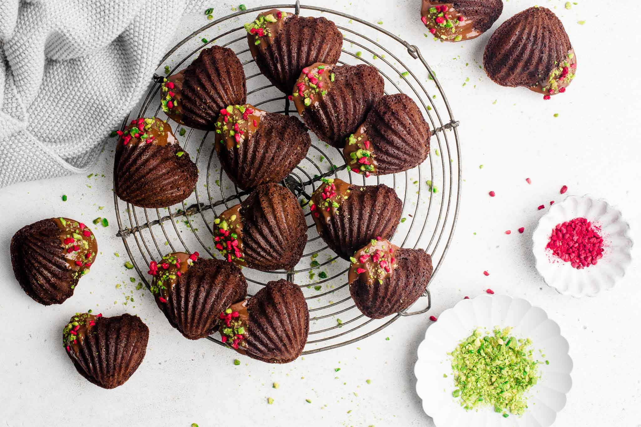 chocolate madeleines on wire rack with decorations