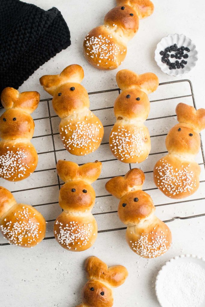zopfhasen or easter bunny rolls on wire rack with pearl sugar