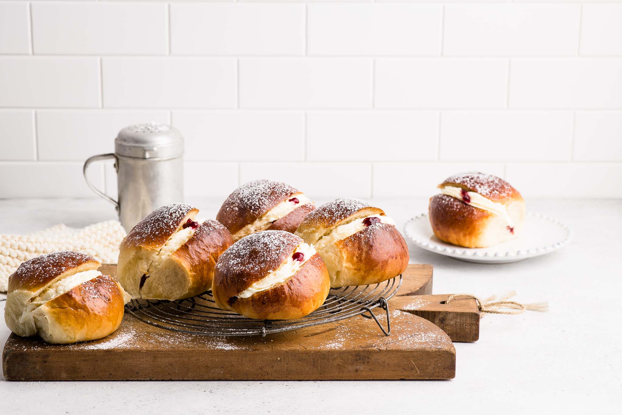 cream buns with jam and cream with icing sugar