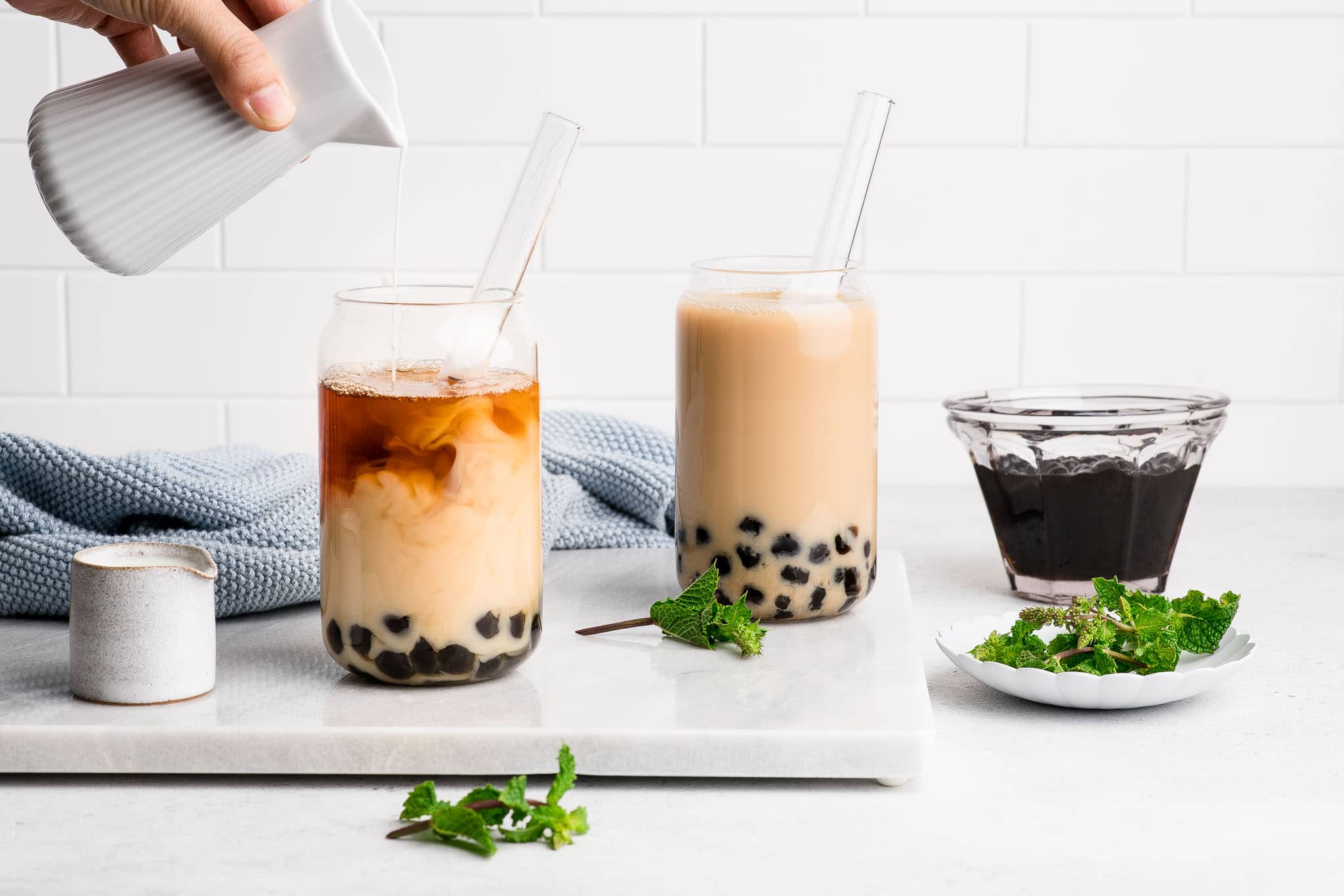 bubble tea with glass straws on marble surface