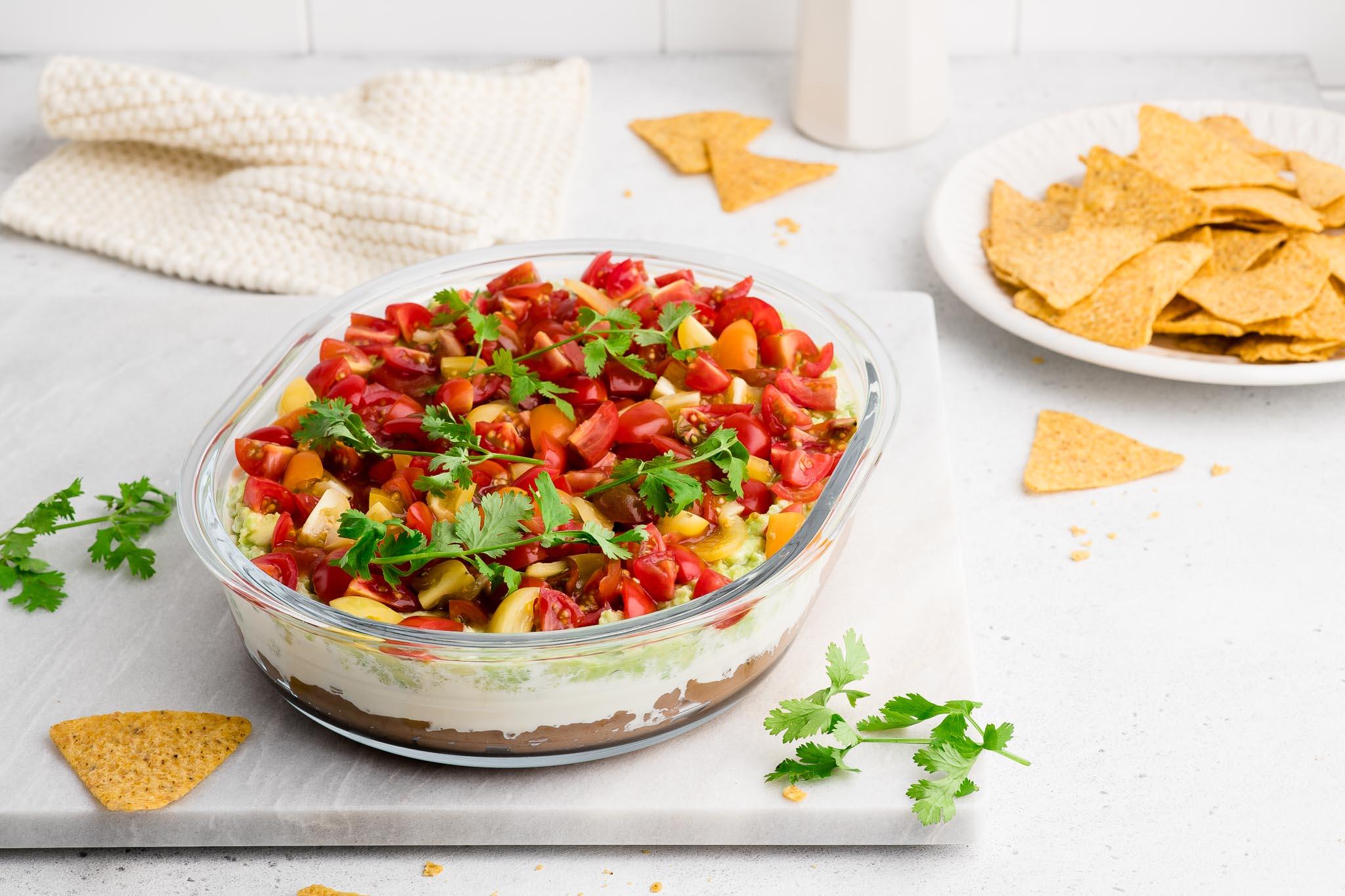 mexican layer dip in glass bowl