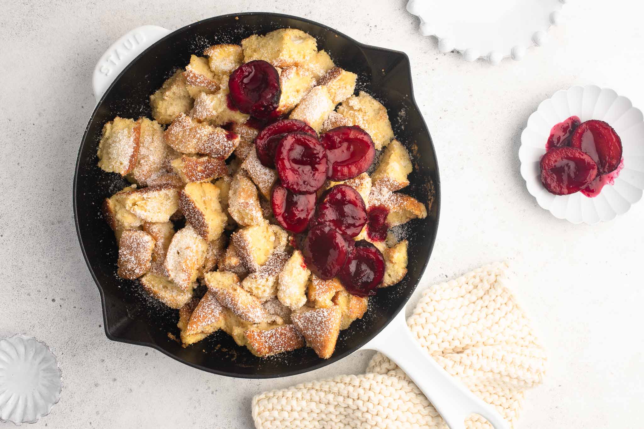 kaiserschmarrn with plum compote in white cast iron pan