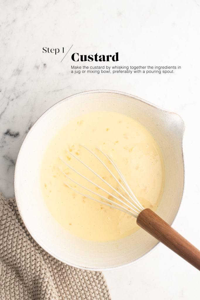 custard in white mixing bowl with whisk