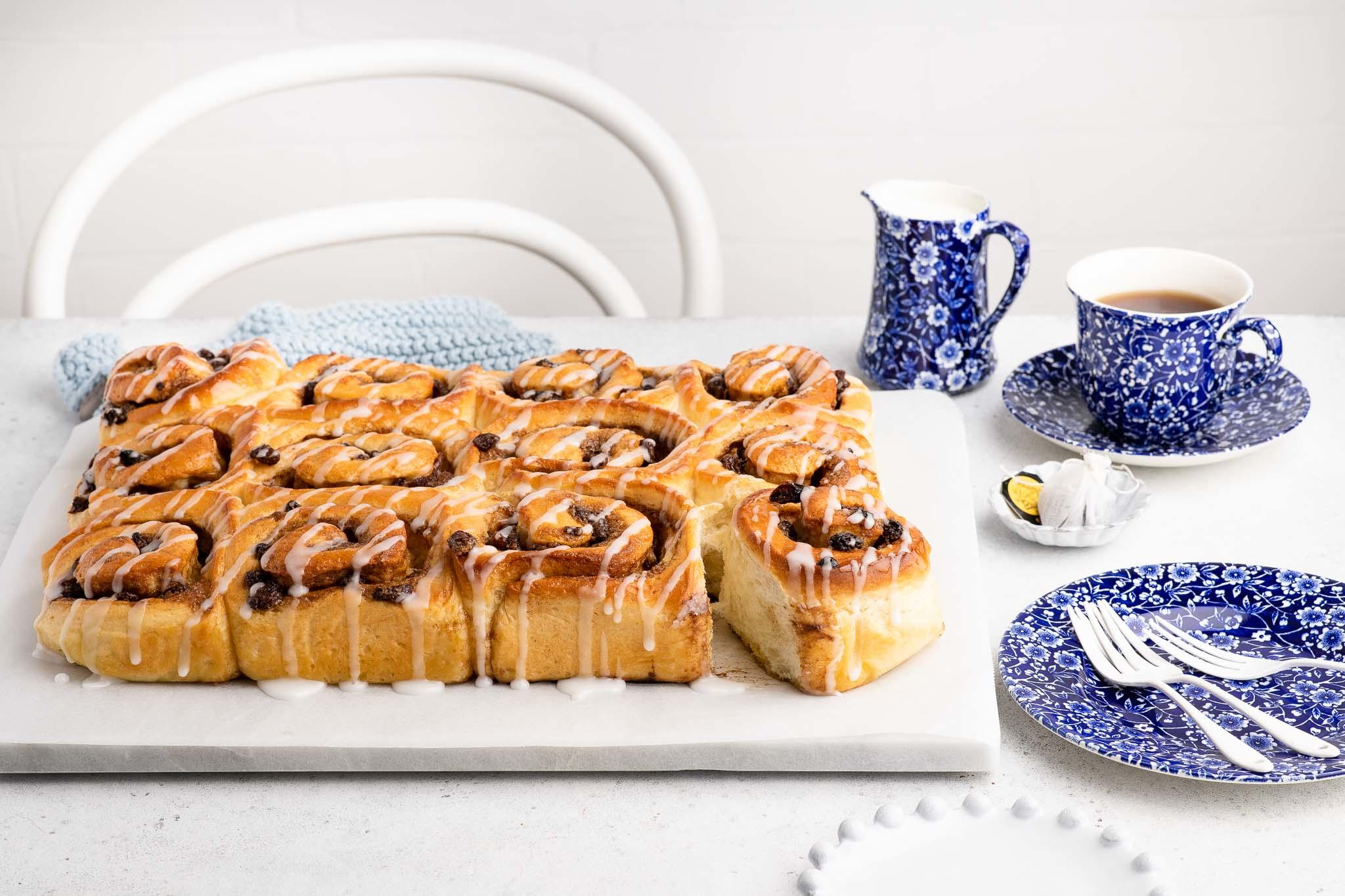 platter of chelsea buns drizzled with icing