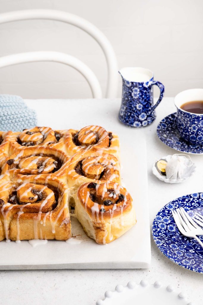 glazed chelsea buns with cup of tea
