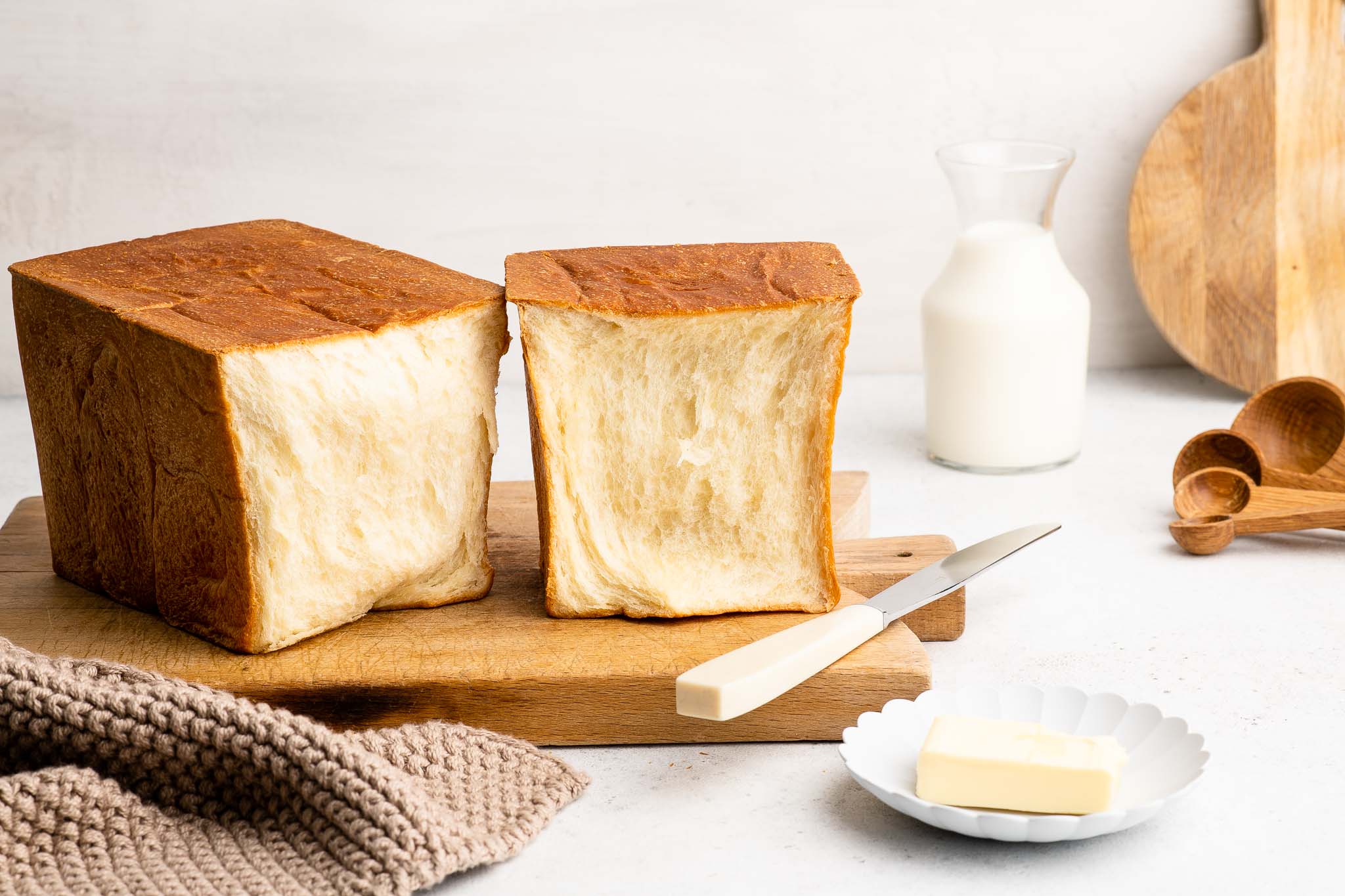Japanese milk bread loaf on wooden board