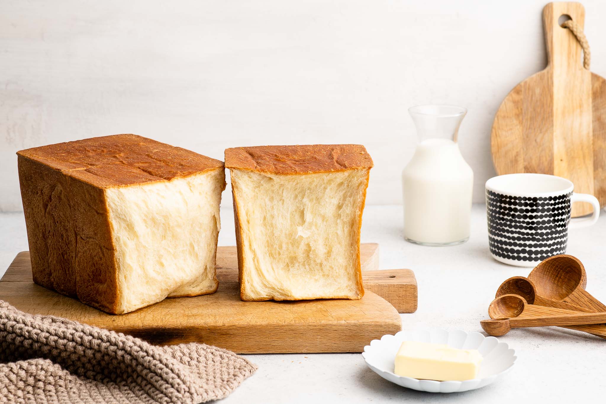 japanese milk bread loaf baked in pullman loaf pan on wooden board