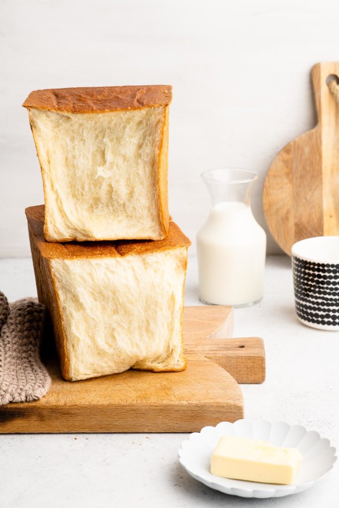 open japanese milk bread loaf on bread board