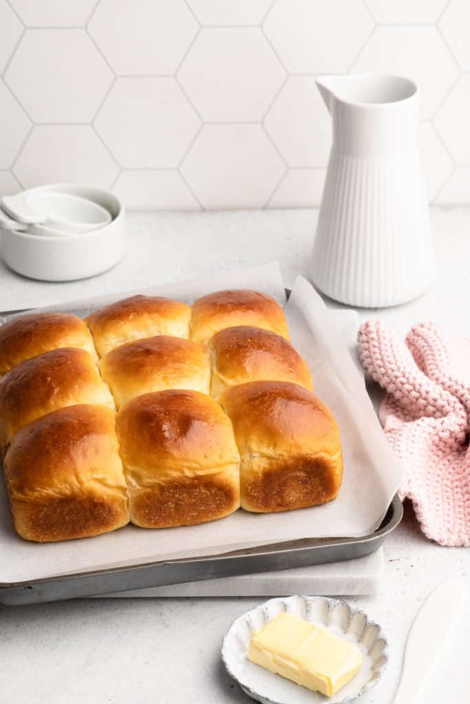 japanese milk buns on metal tray with pink cloth
