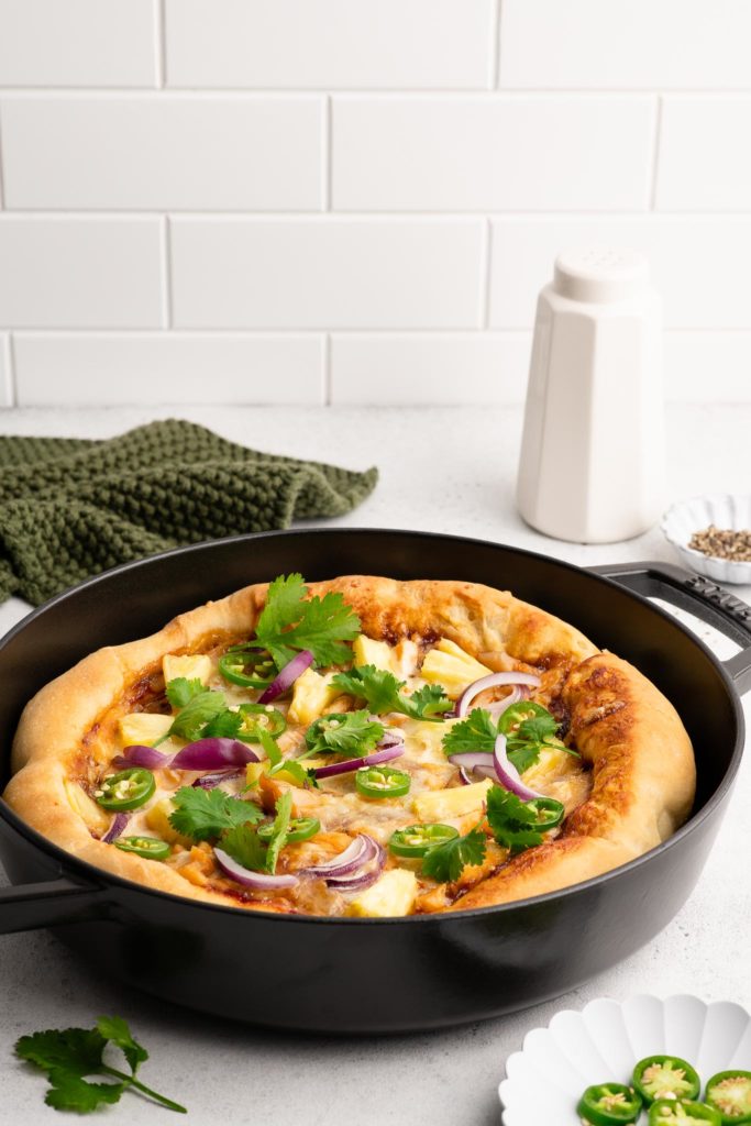bbq chicken pizza in black cast iron pan