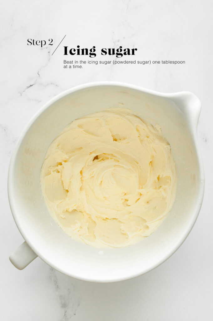 vanilla buttercream frosting in white mixing bowl