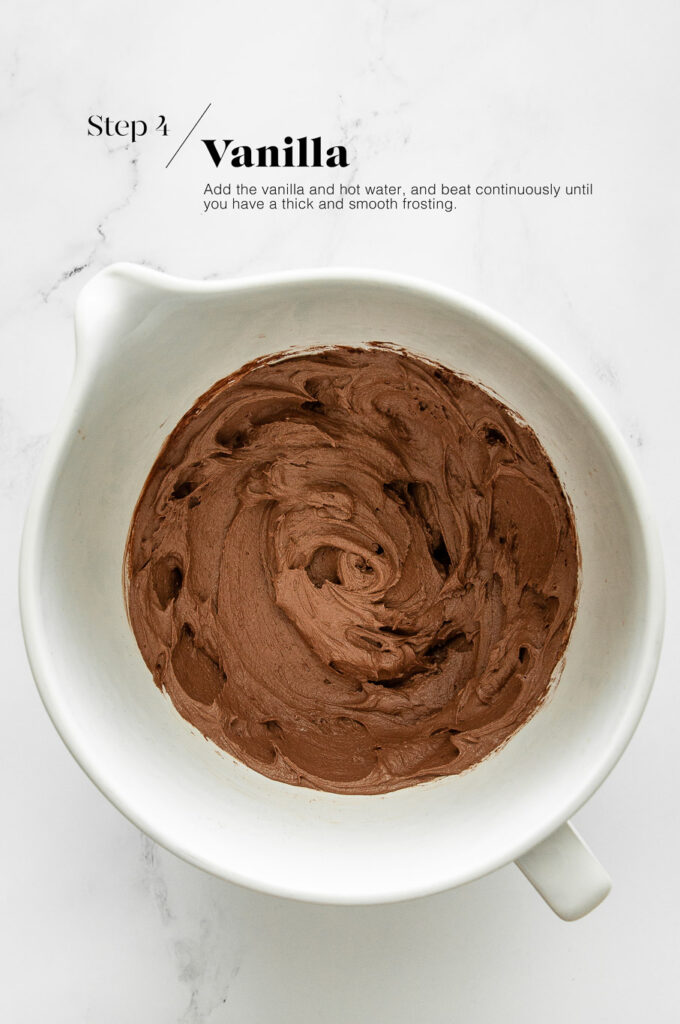 chocolate buttercream frosting in white mixing bowl