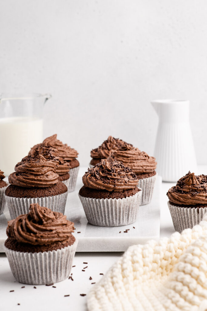 chocolate cupcakes with chocolate buttercream frosting on table