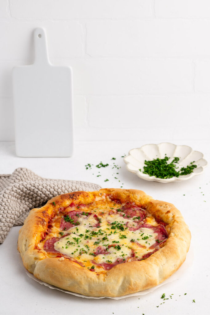 deep dish pizza sprinkled with parsley