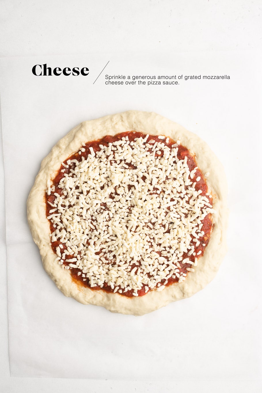 pizza dough with pizza sauce and grated cheese