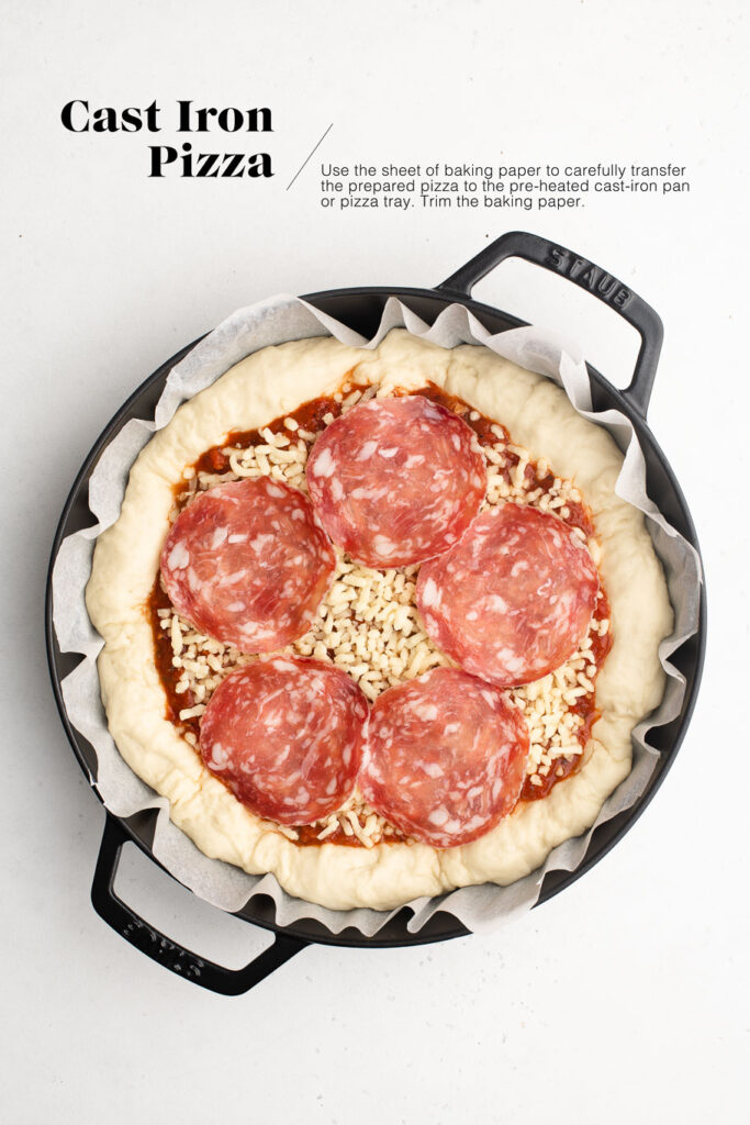 uncooked pizza in cast iron skillet