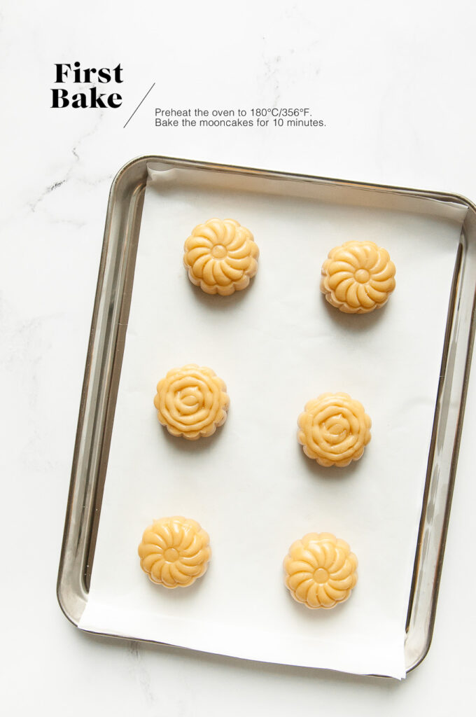 unbaked mooncakes on small baking tray