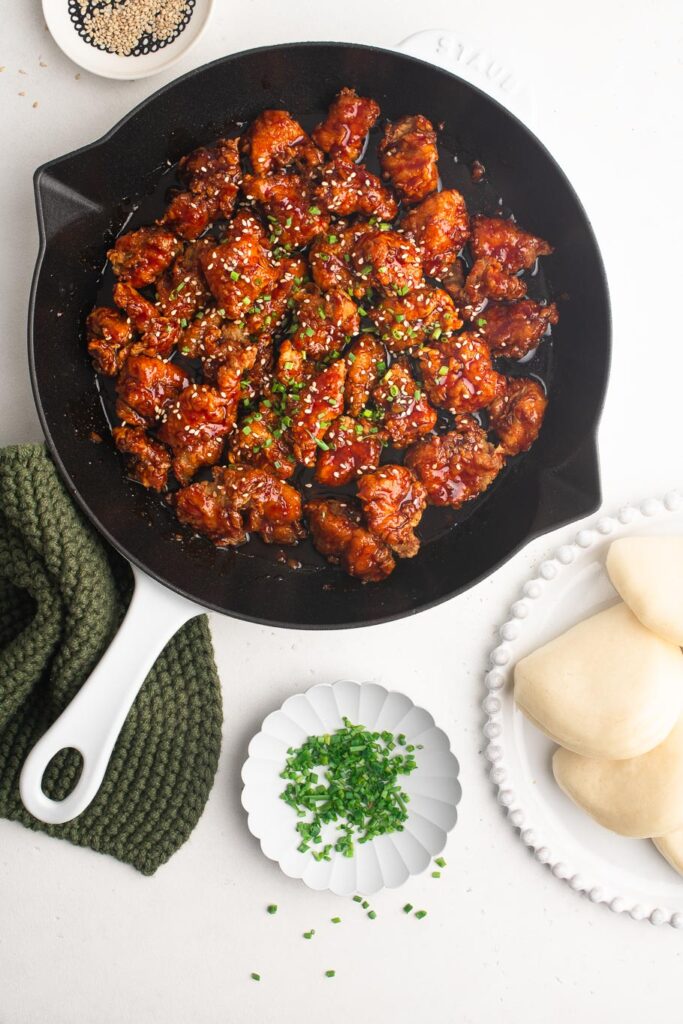 korean fried chicken pieces in cast iron skillet pan
