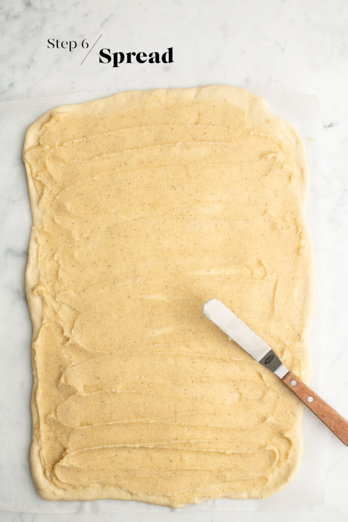 rolled out dough spread with vanilla butter