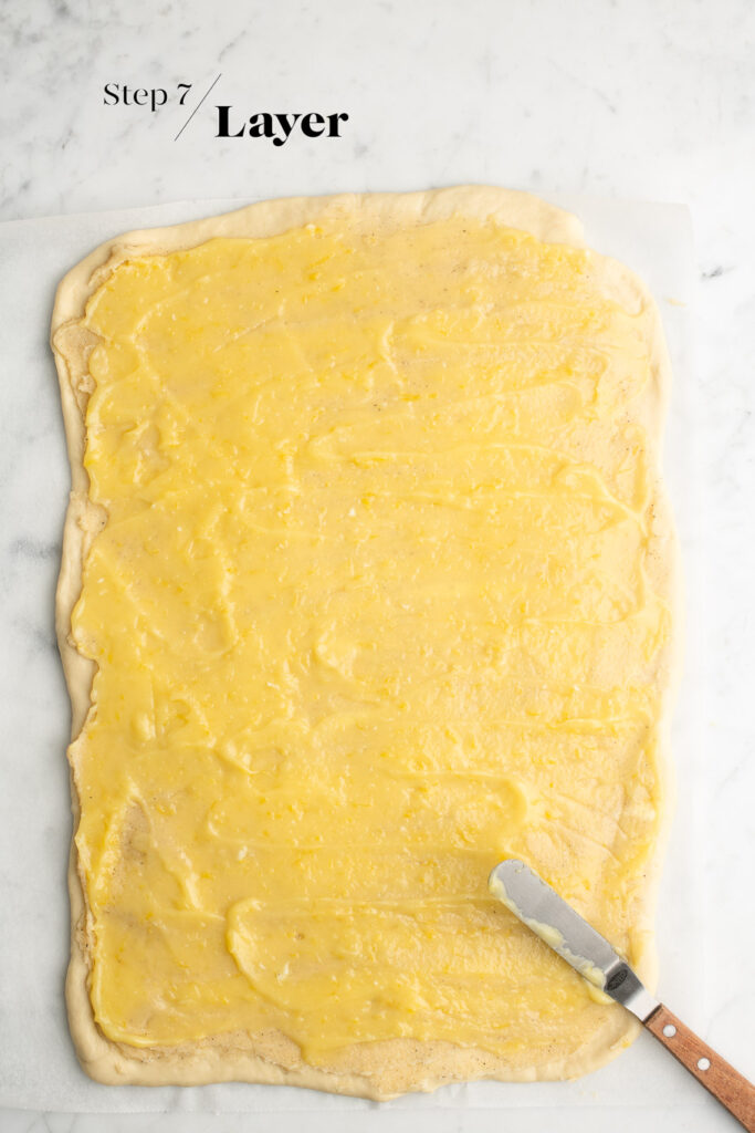 rolled out dough spread with lemon curd