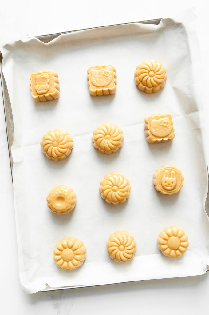 unbaked mooncakes with lotus seed paste and salted egg yolks on baking tray