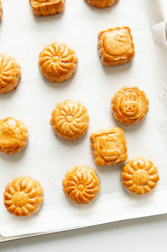 mooncakes with lotus seed paste and salted egg yolks on baking tray