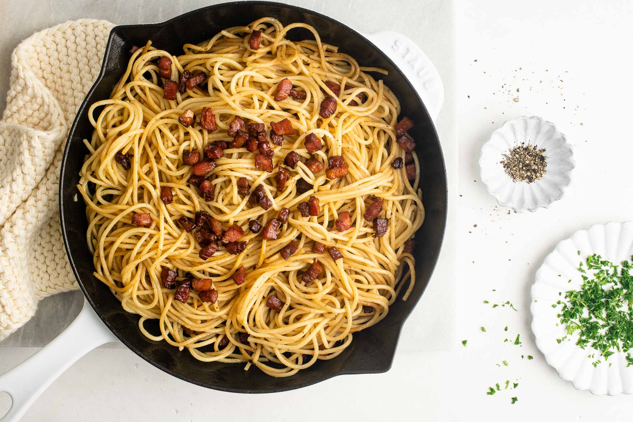 pasta with pancetta on marble table