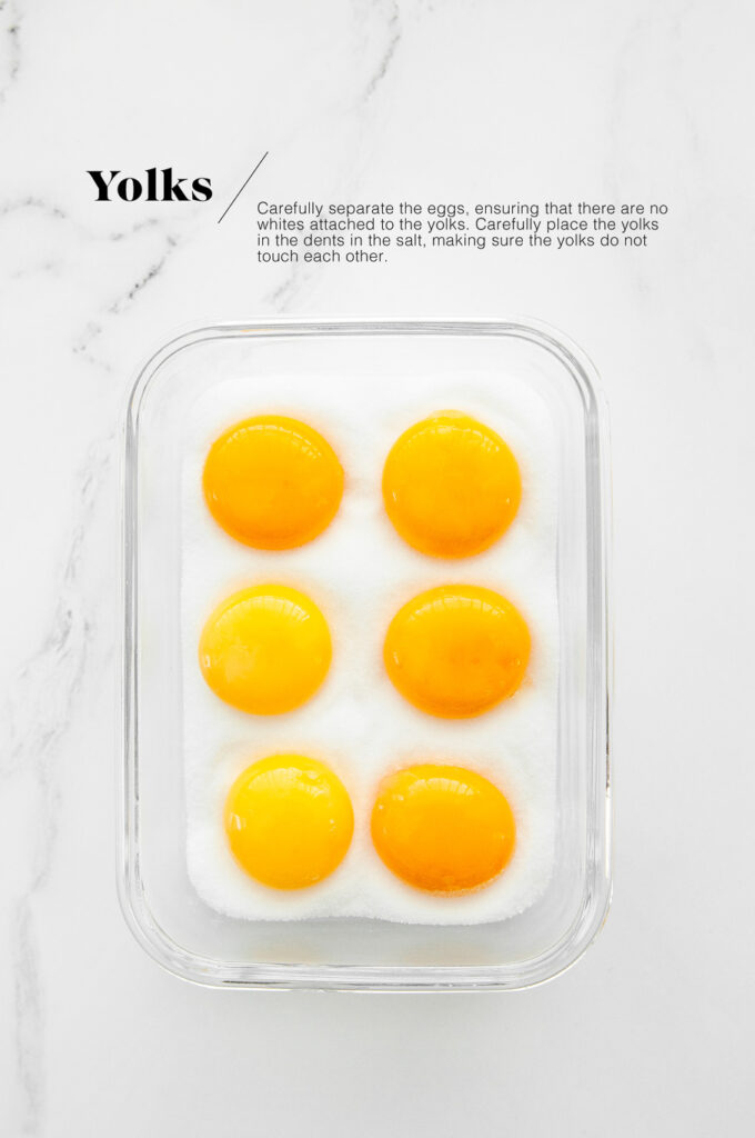 egg yolks on fine salt in container