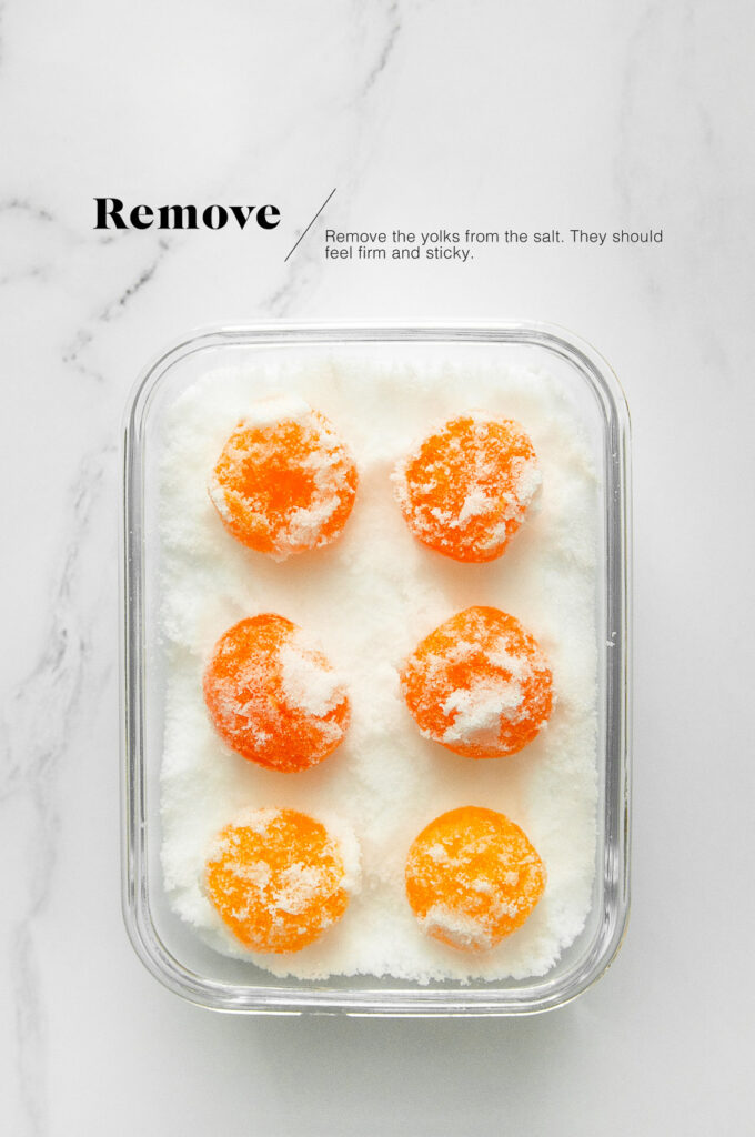 cured egg yolks in salt in glass container