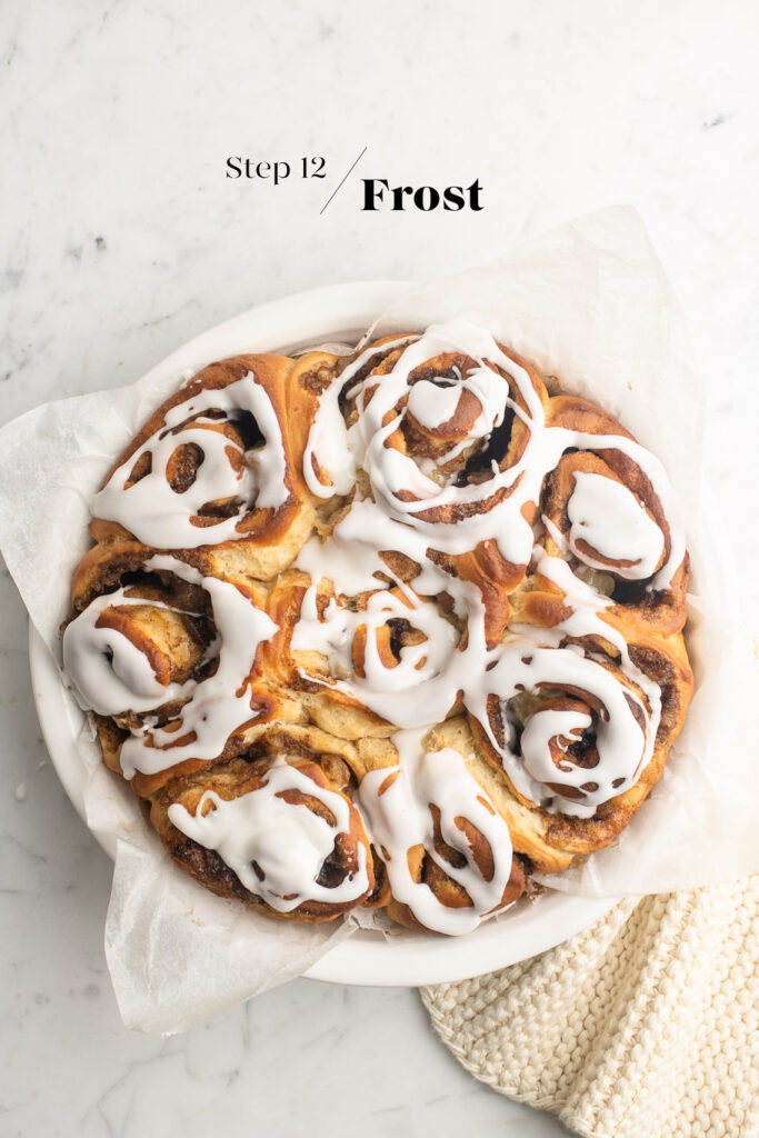 apple cinnamon rolls with frosting on marble table