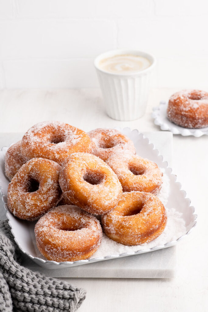 white plate with cinnamon sugar donuts