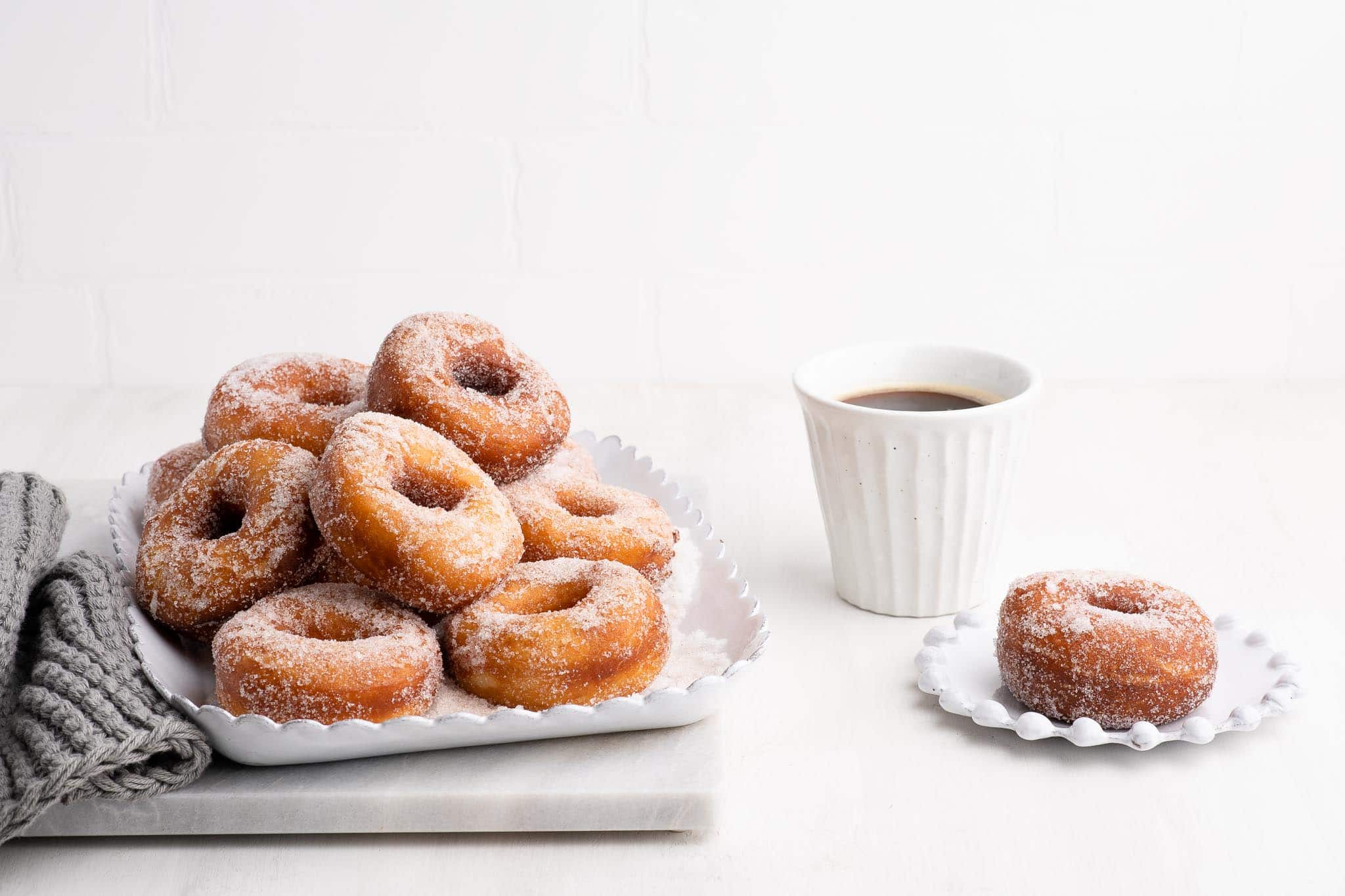 stack of cinnamon donuts on white plate