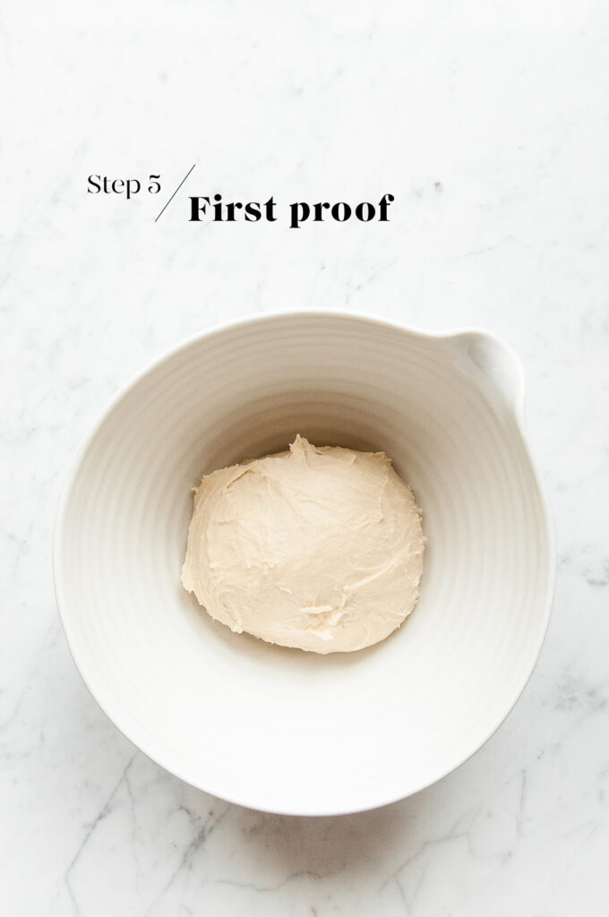 proving dough in white mixing bowl